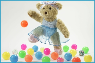 Photo of Melody Bear dancing with coloured bouncy balls